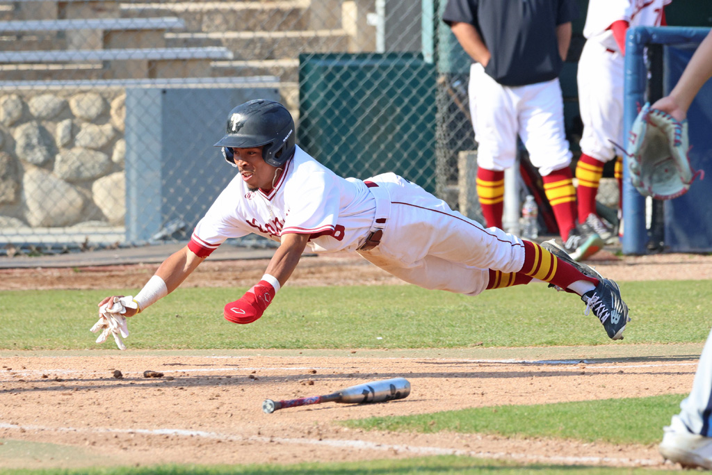 Aryonis Harrison goes head first to score a run during Friday's win (photo by Richard Quinton).