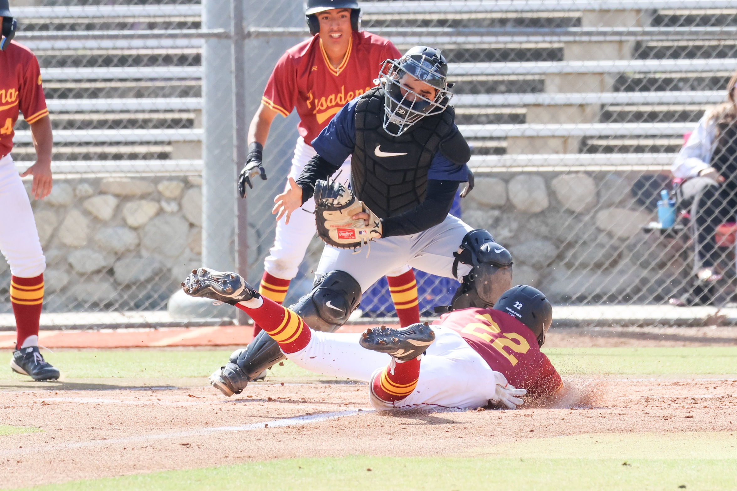 Ricky Gonzales makes the head-first slide at home to score a run on Saturday (photo by Richard Quinton).