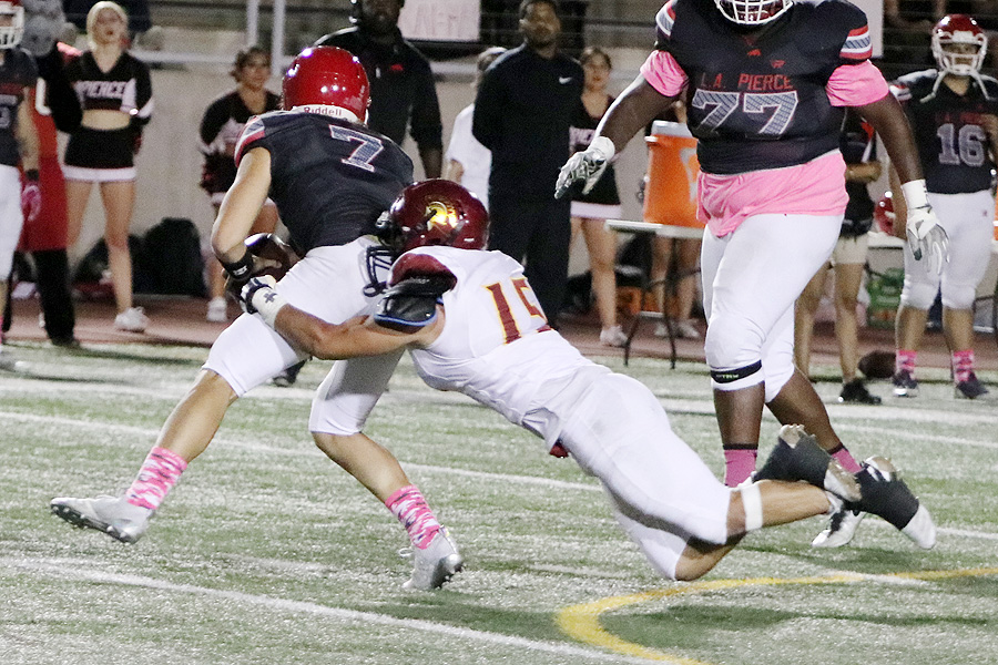 PCC lineman Hector Palacios makes a diving grasp of Pierce quarterback Jonathan Saavedra during the Lancers loss in Woodland Hills Saturday evening, photo by Richard Quinton.