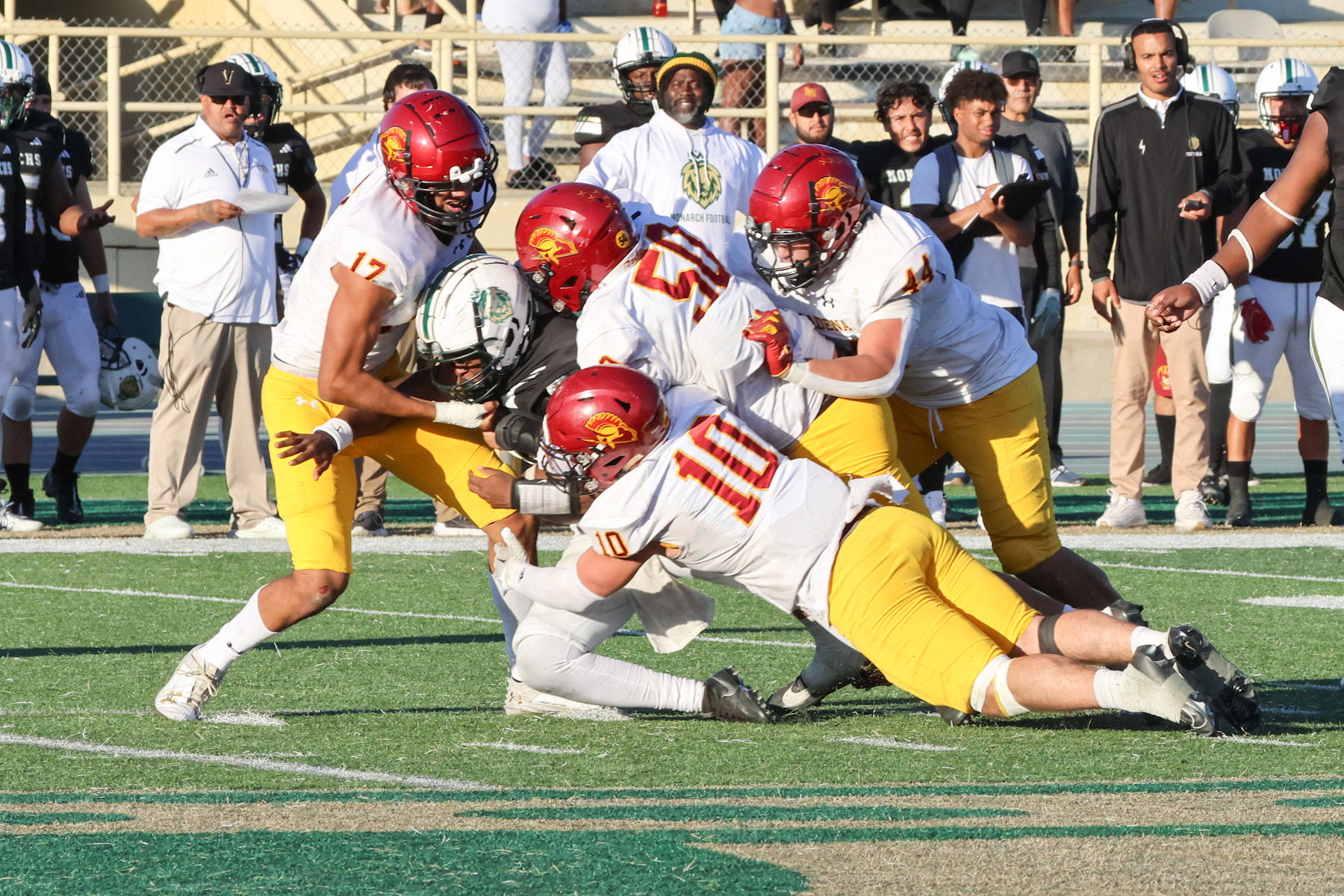 Michael Prappas (10), Mario Luna (50), Adrian Ramirez (44) and Ceasar Ramirez converge on a tackle in PCC's win (photo by Richard Quinton).