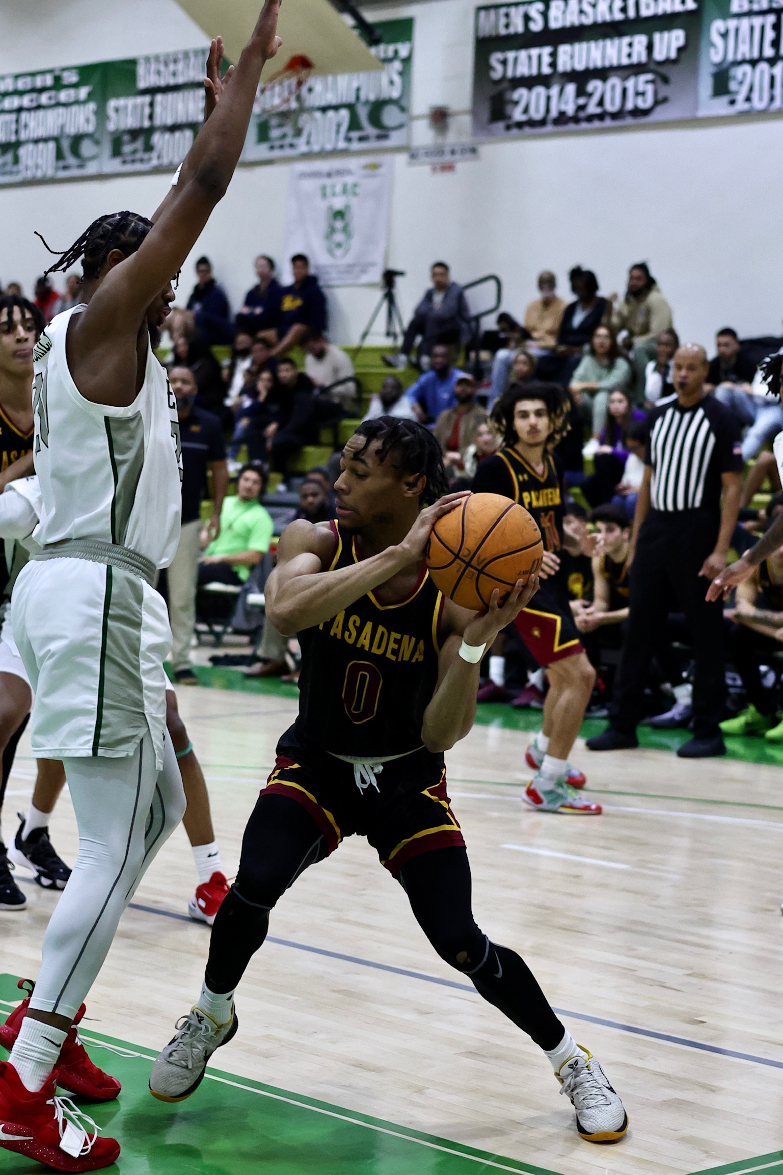 Rande Harper is defended well in the post by East LA as the Lancers 11-game win streak was stopped (photo Michael Watkins).