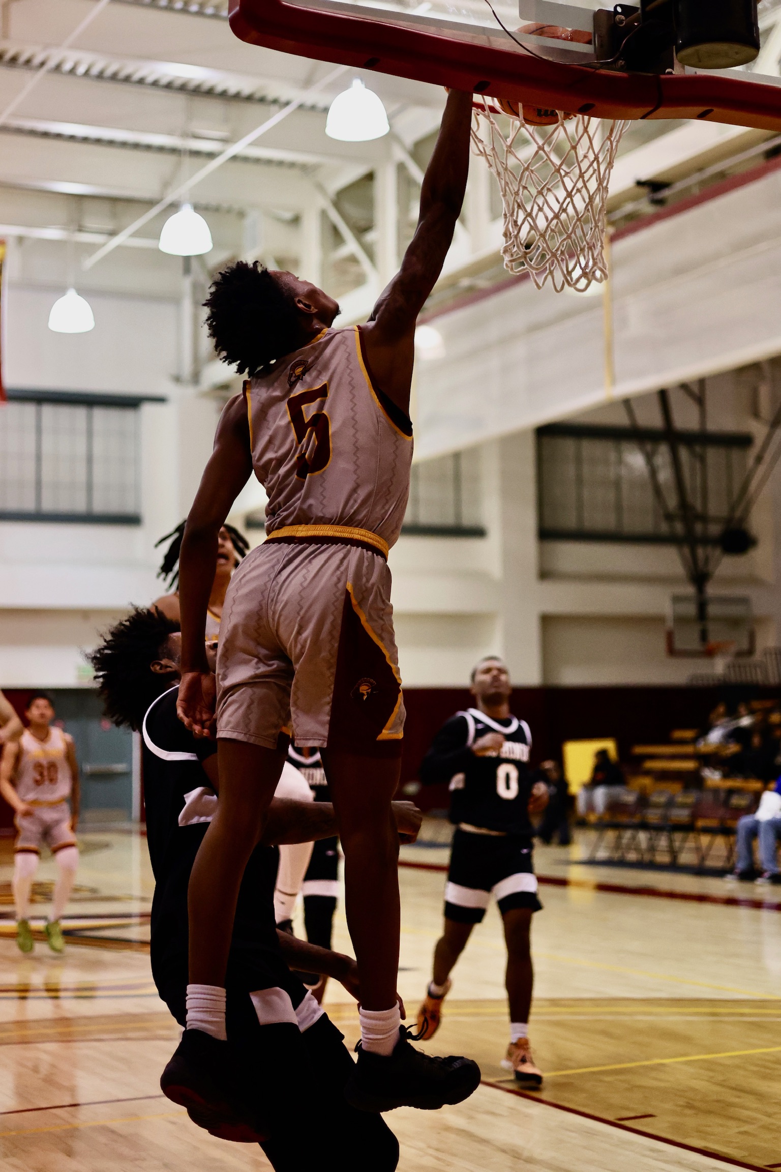 Myles Watkins goes up for the dunk in PCC's 11th consecutive win on Friday night (photo by Michael Watkins).