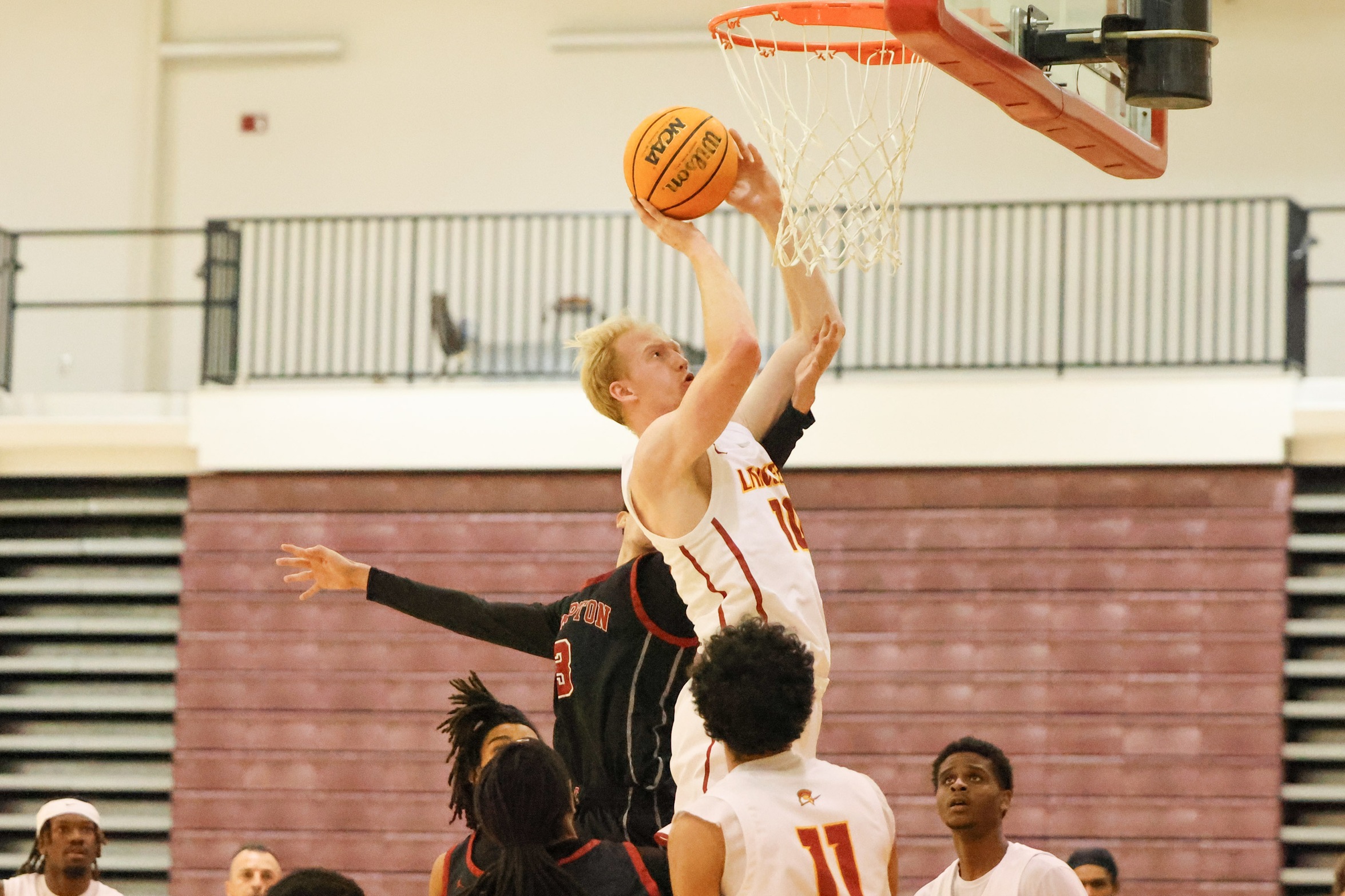 Cooper Creamer goes to the basket in Tuesday's loss (photo by Richard Quinton).