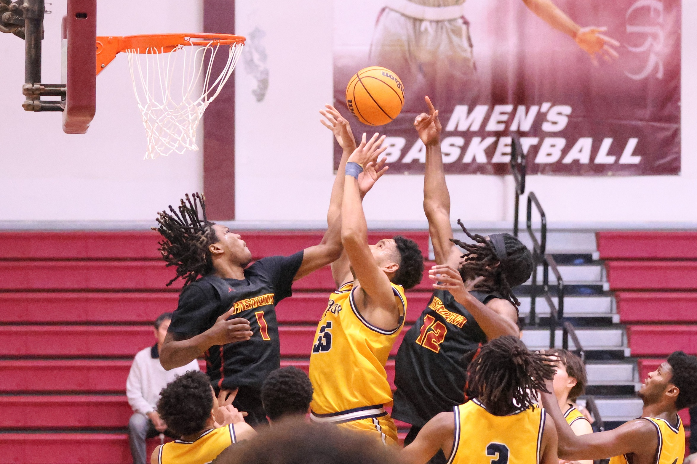 Brandin Jackson goes for the loose ball before putting in the winning basket with Donovan Ford on right (photo by Richard Quinton).