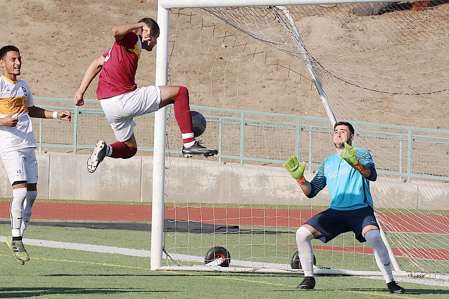 Lancer David Vasquez-Mena goes up high re-direct a free kick by teammate Anthony Jimenez to score the first of his two goals on Tuesday, photo by Richard Quinton.