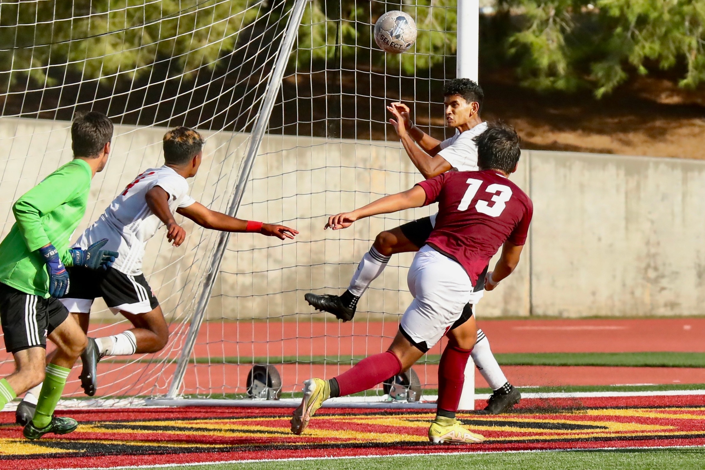 Esai Matchan kicks in the rebound game-tying goal in PCC's 2-2 tie Friday at Robinson Stadium (photo by Michael Watkins).