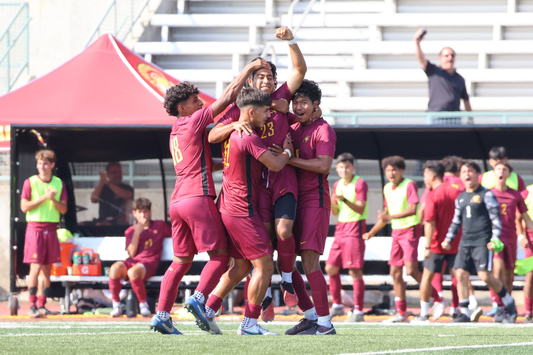 Alejandro Concepcion mobbed by teammates after his game-tying goal on Tuesday (photo by Richard Quinton).