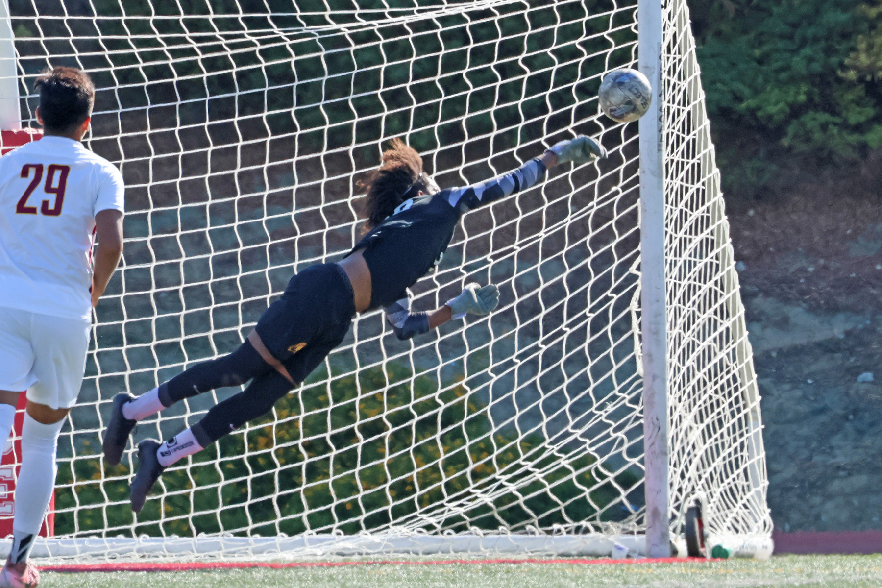 Rayshon Robert with the leaping save in PCC's win at Pierce College (photo and gallery by Richard Quinton).