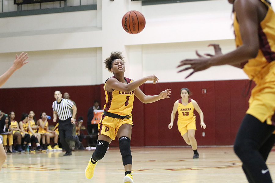 Lancers point guard Cosette Balmy fires a pass during a home game last month.