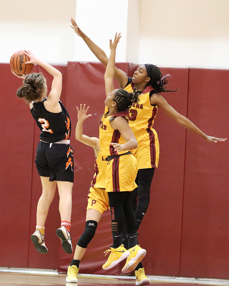 Dariel Johnson (arms spread out) and Cosette Balmy put defensive pressure on a Ventura shooter during the Lancers 62-41 win on Wednesday night.
