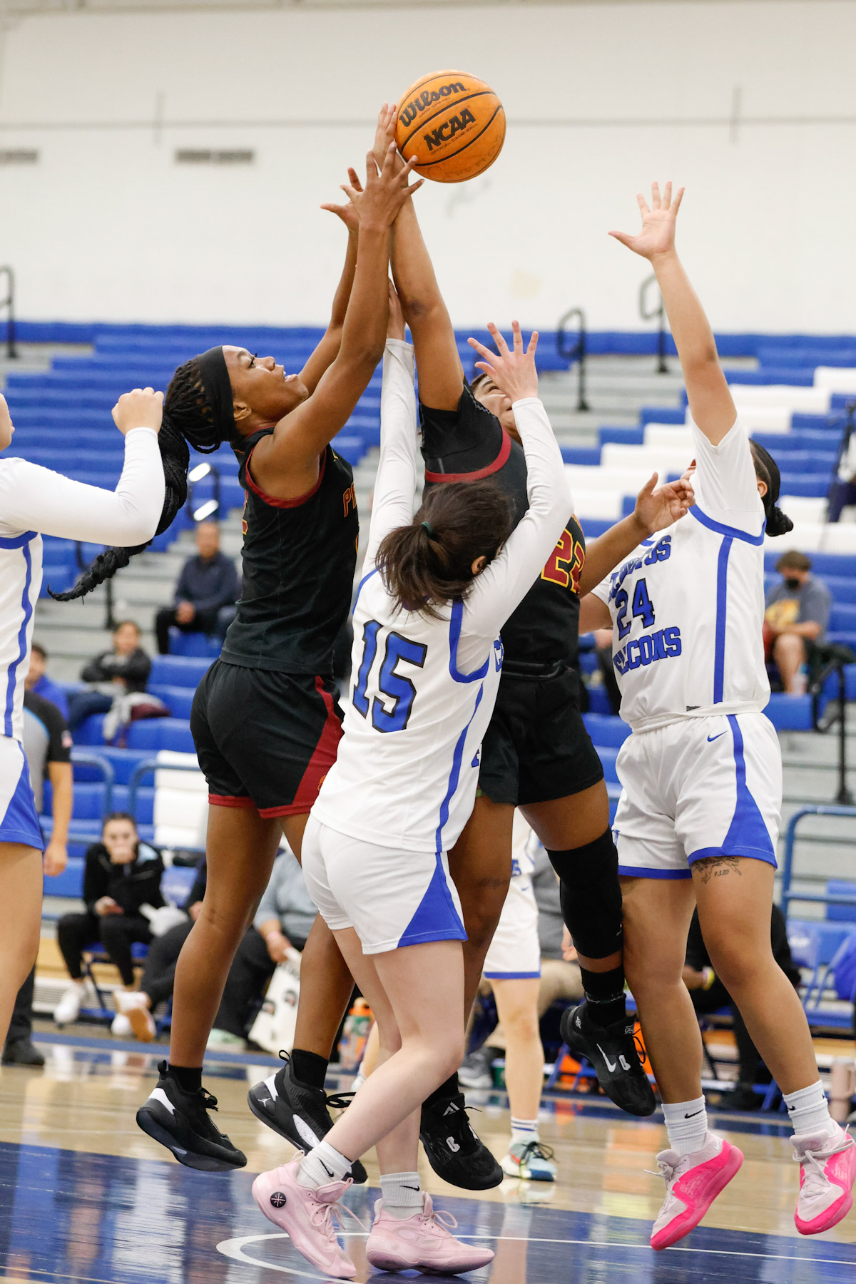 Abigail Saville (left) battles for the loose ball in the team's loss at Cerritos College (photo by Richard Quinton).