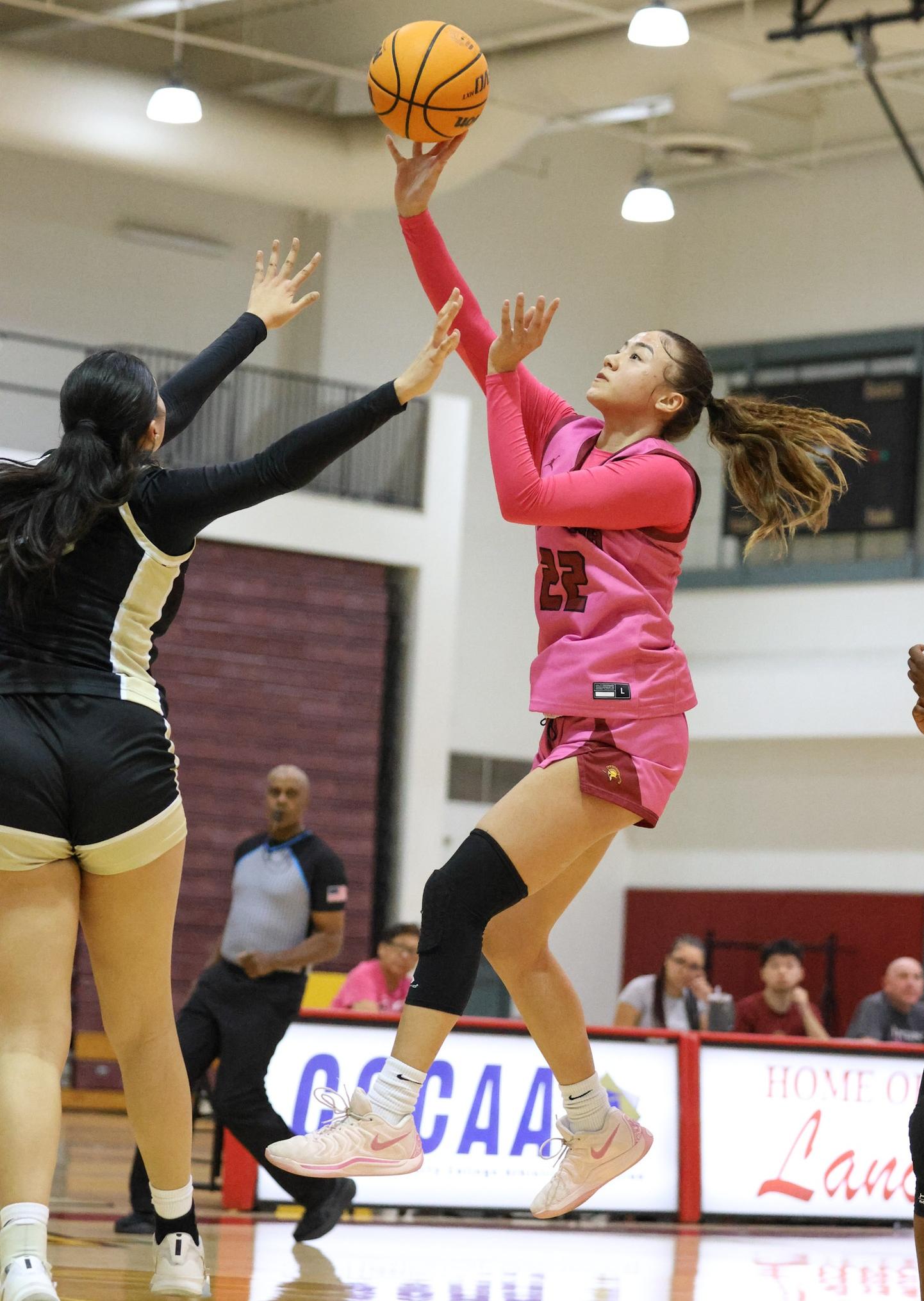 Kamora Fletcher goes up for the basket as PCC donned its Pink home uniforms on Wednesday (photo by Richard Quinton).