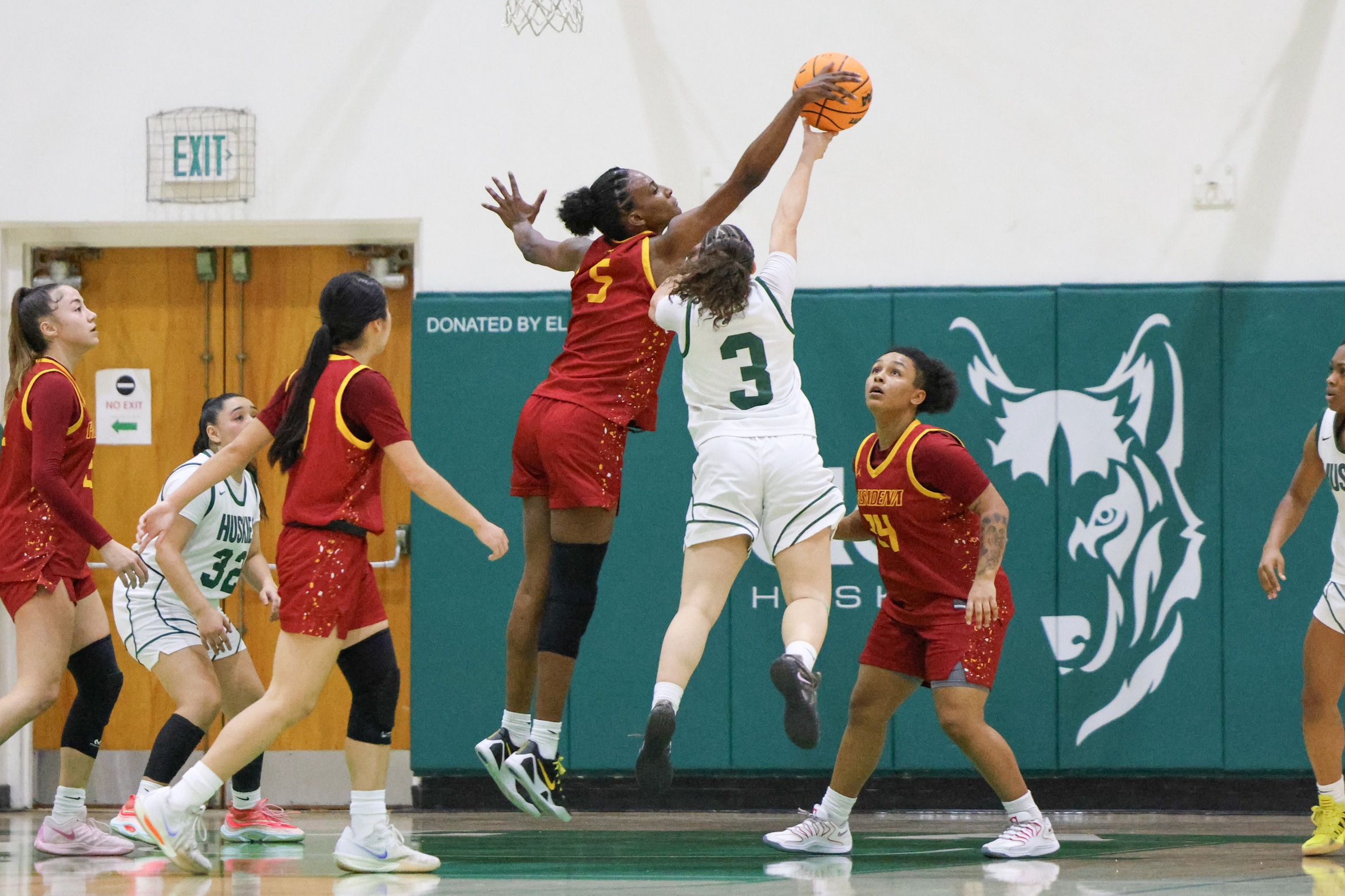 Celine Bolton-Ford makes one of her nine blocks on Friday night at East LA College (photo by Richard Quinton).