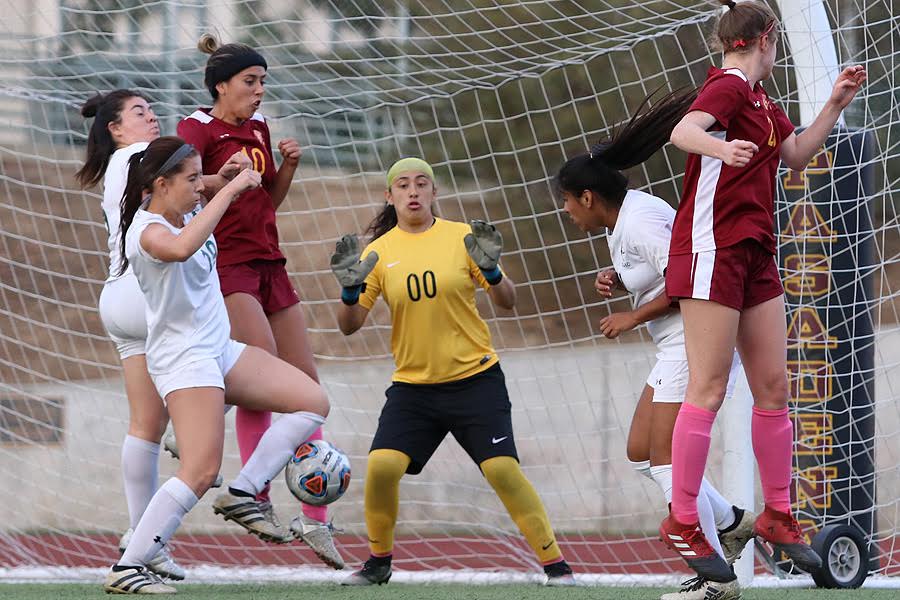Alexxis Molinar (far left) gets control of this throw-in and then scored the tying goal in PCC's 1-1 deadlock v. East Los Angeles Tuesday at Robinson Stadium, photo by Richard Quinton.