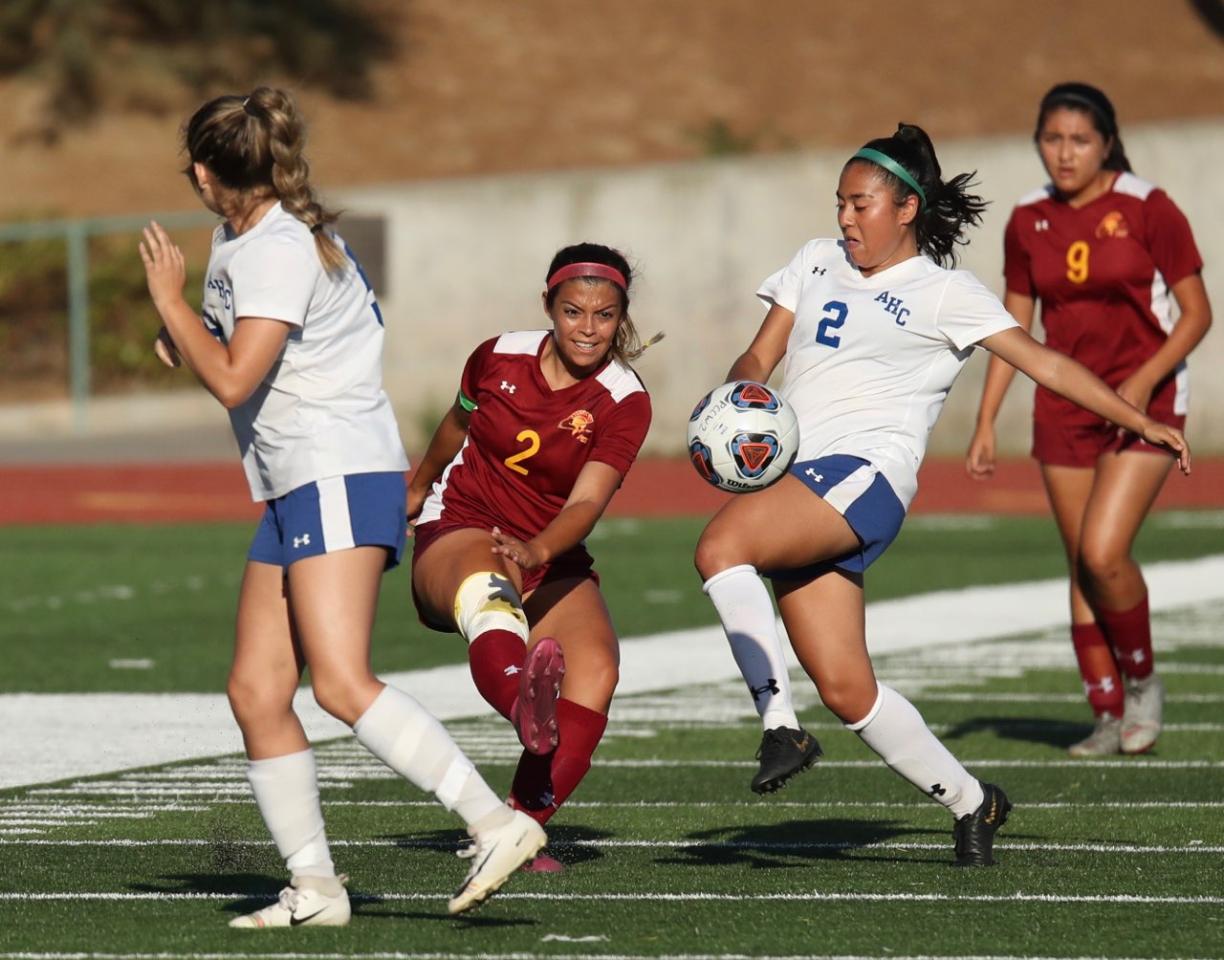 Lancer Erica Perez drives a kick between two Allan Hancock players during PCC's 1-1 tie Friday at Robinson Stadium, photo by Michael Watkins.