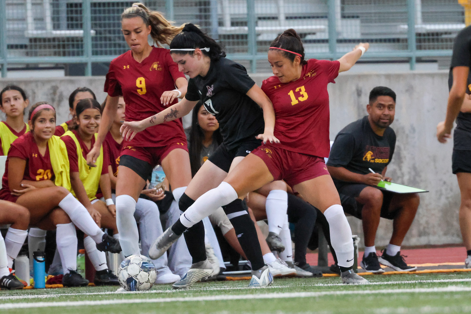 Angely Puga battles for the ball with teammate Riley Buck assisting during PCC's win on Saturday night (photo by Richard Quinton).