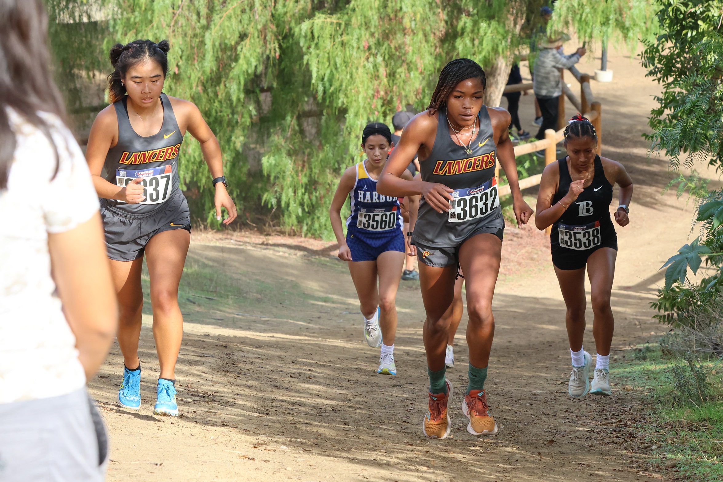 Deniya Fields (right) and Ellen Kim (left) in action at the SCC Championships at Mt. San Antonio College (photo by Richard Quinton).